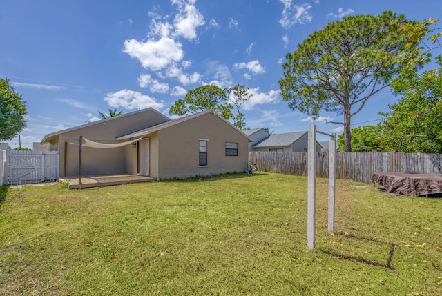 view of property exterior featuring a lawn, a fenced backyard, stucco siding, and a patio