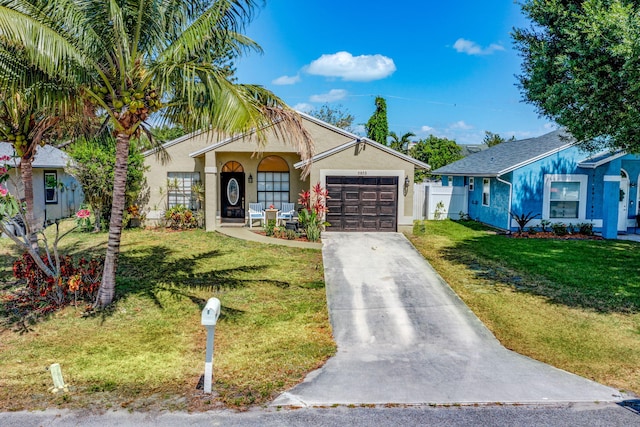 ranch-style home with a garage, fence, a front yard, stucco siding, and concrete driveway