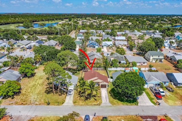drone / aerial view featuring a water view and a residential view
