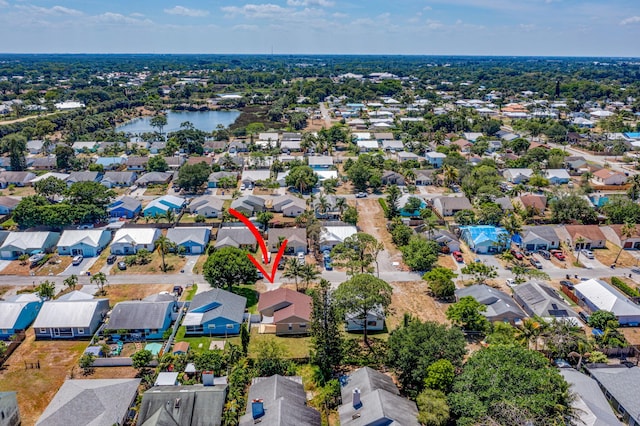 bird's eye view featuring a water view and a residential view
