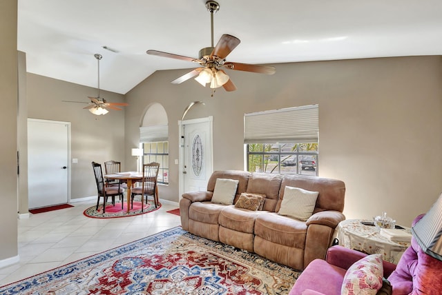living room with high vaulted ceiling, a ceiling fan, baseboards, light tile patterned floors, and visible vents