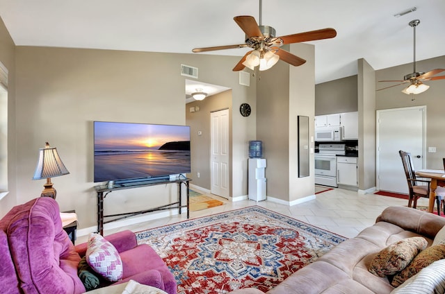 living room with a ceiling fan, high vaulted ceiling, visible vents, and baseboards