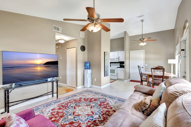 living area with visible vents, a ceiling fan, baseboards, and high vaulted ceiling