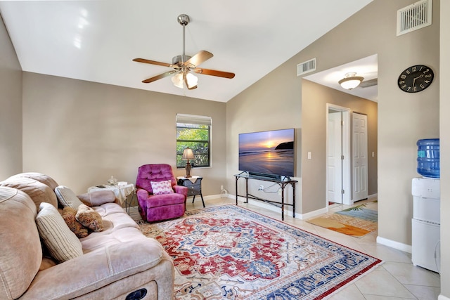 living area with light tile patterned floors, a ceiling fan, lofted ceiling, and visible vents