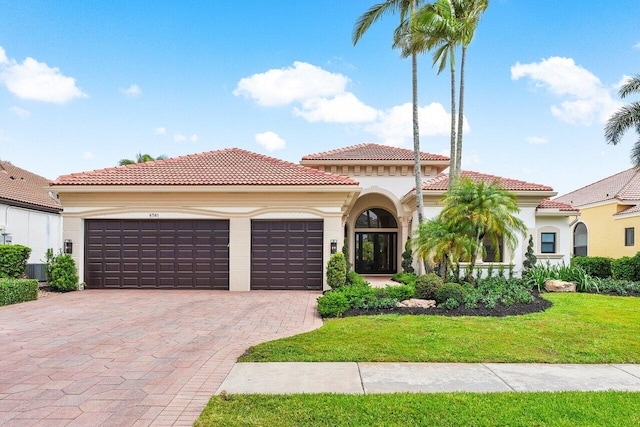 6581 Grande Orchid Way, Delray Beach, FL 33446 - mediterranean / spanish-style home featuring stucco siding, a garage, decorative driveway, and a tiled roof