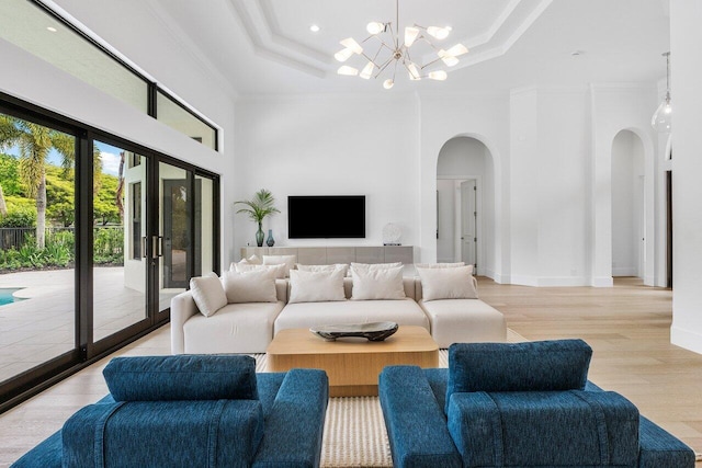 6581 Grande Orchid Way, Delray Beach, FL 33446 - living area featuring arched walkways, wood finished floors, a raised ceiling, crown molding, and a chandelier