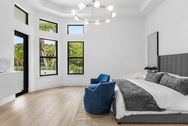 6581 Grande Orchid Way, Delray Beach, FL 33446 - bedroom with a chandelier, wood finished floors, and a high ceiling
