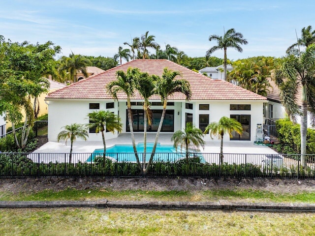exterior space featuring a fenced backyard, a tiled roof, a patio area, and stucco siding