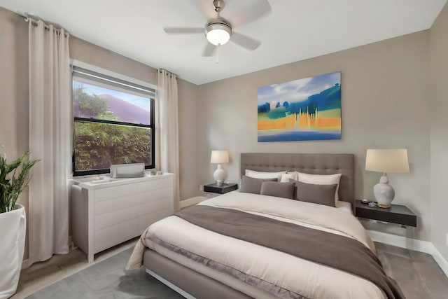 bedroom featuring baseboards and ceiling fan