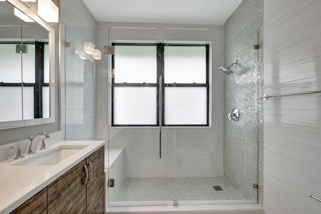 full bath with vanity and a shower stall