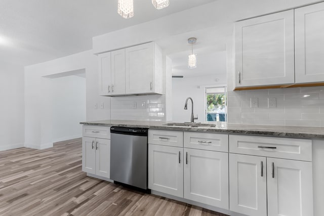 9603 NW 72nd Mnr, Tamarac, FL 33321 - kitchen featuring tasteful backsplash, stainless steel dishwasher, white cabinetry, a sink, and light wood-style flooring
