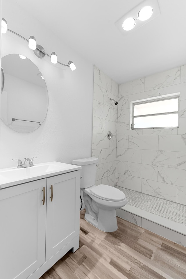 9603 NW 72nd Mnr, Tamarac, FL 33321 - bathroom featuring vanity, toilet, tiled shower, and wood finished floors