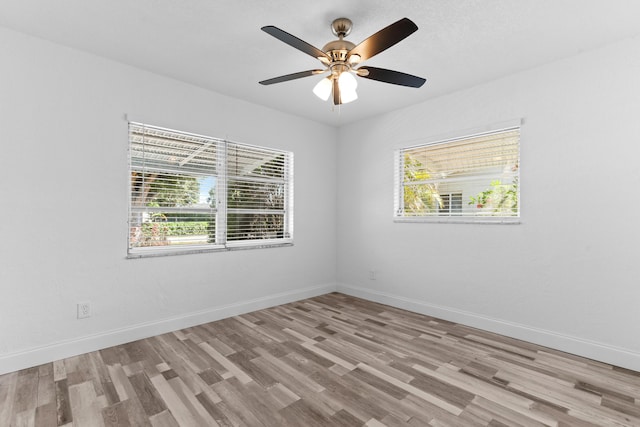 9603 NW 72nd Mnr, Tamarac, FL 33321 - spare room featuring baseboards, plenty of natural light, and wood finished floors