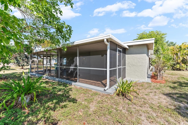 9603 NW 72nd Mnr, Tamarac, FL 33321 - back of house featuring a sunroom and stucco siding