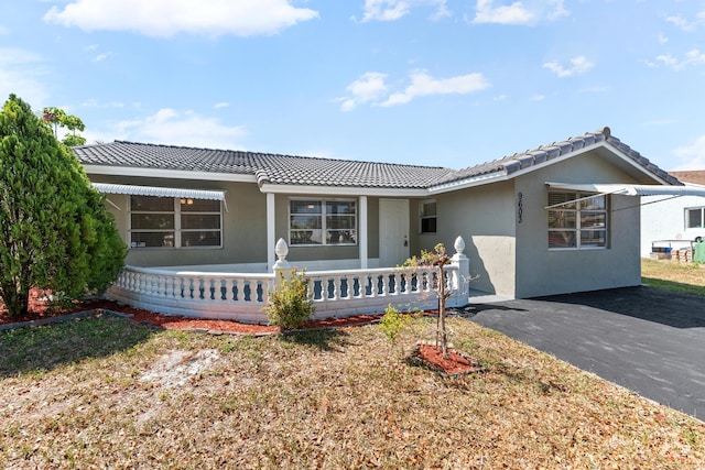 9603 NW 72nd Mnr, Tamarac, FL 33321 - view of front of property with a porch, a tiled roof, and stucco siding