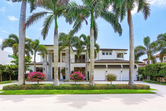 view of front of home featuring a garage, concrete driveway, and stucco siding