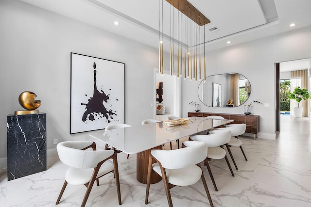 dining area featuring light marble finish floors, recessed lighting, baseboards, and a high ceiling