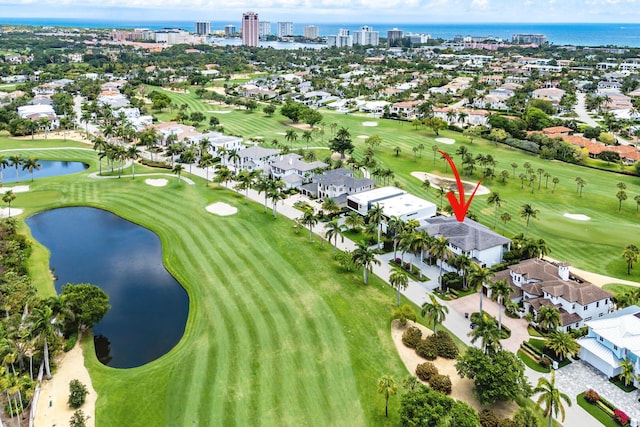 aerial view of property's location featuring nearby suburban area, a large body of water, and a golf course