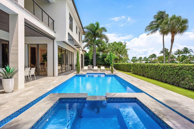 view of swimming pool featuring an in-ground hot tub and a patio