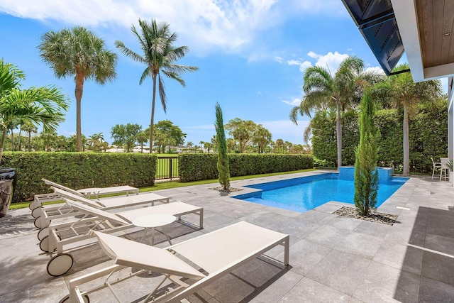 view of pool with a patio and fence