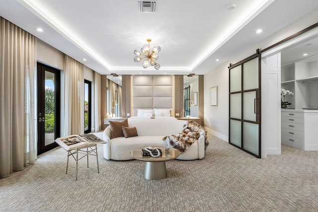 bedroom with a barn door, carpet, access to exterior, a raised ceiling, and recessed lighting