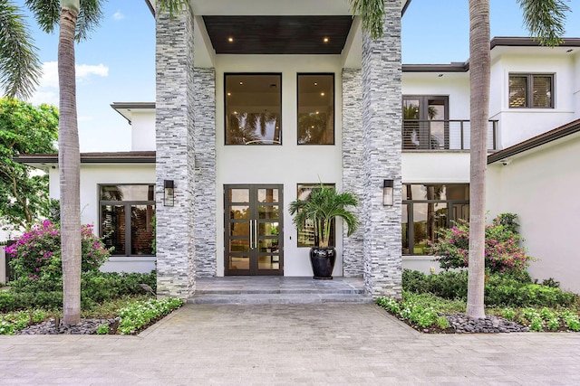 entrance to property with french doors and stucco siding