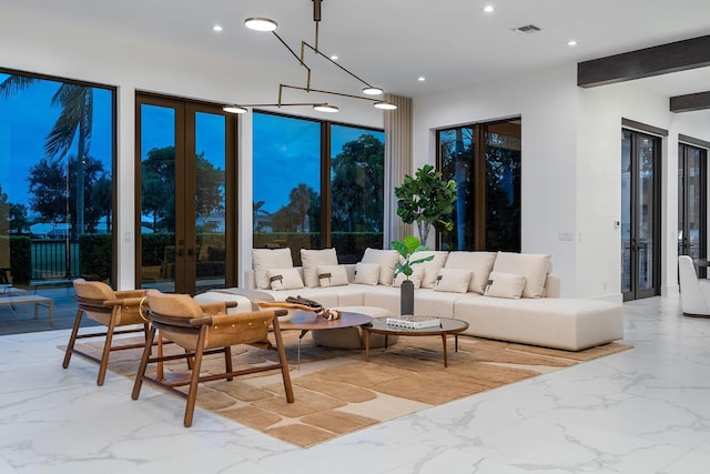 living area featuring french doors, light marble finish floors, and recessed lighting