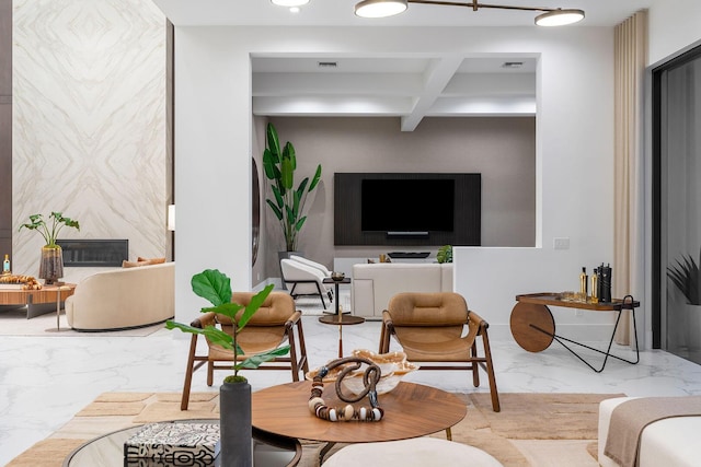 living area featuring marble finish flooring, beamed ceiling, and coffered ceiling