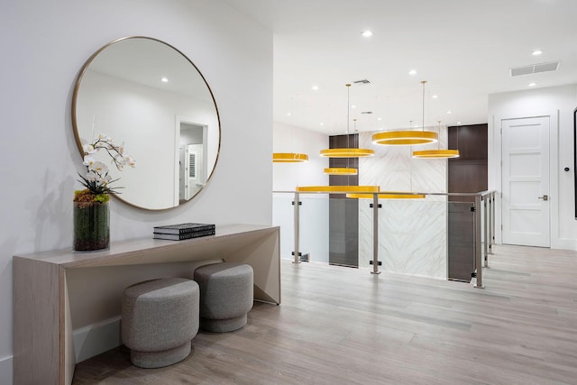 kitchen featuring light wood-style flooring, hanging light fixtures, and recessed lighting