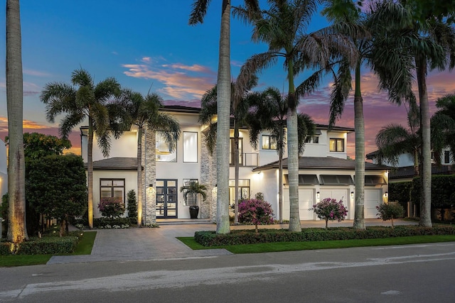 view of front facade featuring french doors and stucco siding