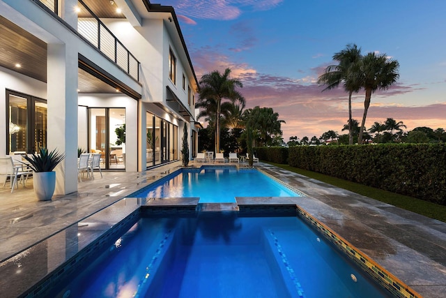 view of pool with a pool with connected hot tub and a patio area