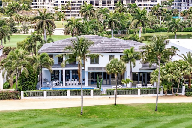 back of house featuring fence, a balcony, and a patio