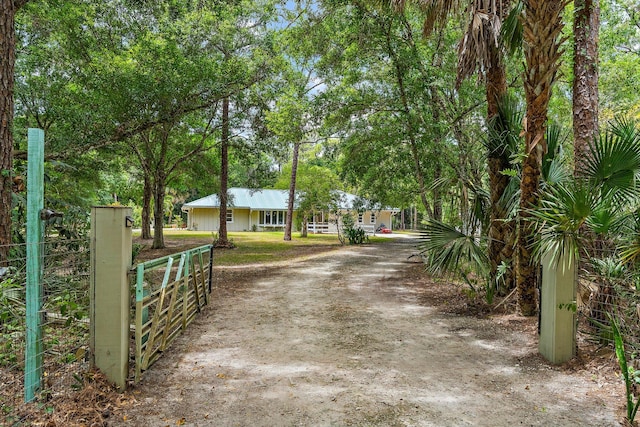view of street with a gated entry and driveway