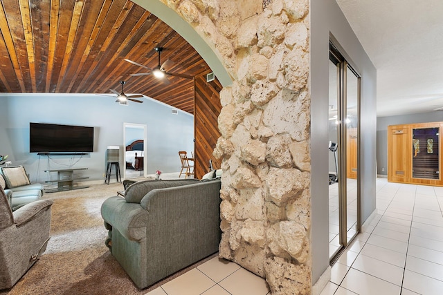 living area with lofted ceiling, ceiling fan, wooden ceiling, arched walkways, and light tile patterned floors