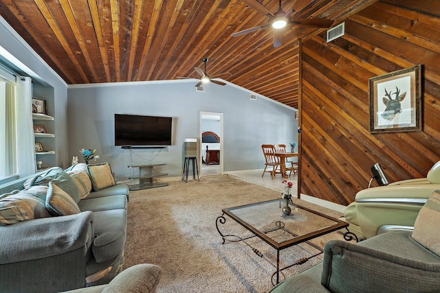 living room with wood ceiling, wood walls, a ceiling fan, and carpet flooring