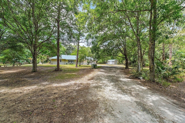 view of street featuring dirt driveway