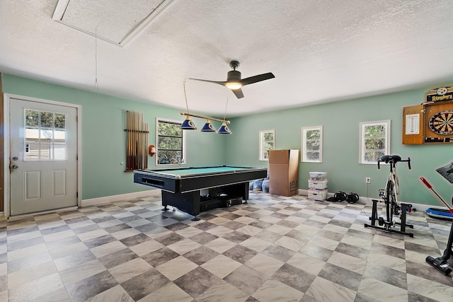 playroom with baseboards, a healthy amount of sunlight, and attic access