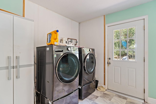 washroom featuring separate washer and dryer and laundry area