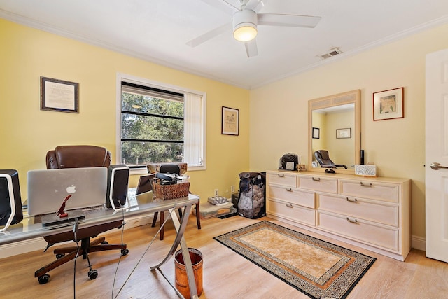 office featuring ornamental molding, a ceiling fan, light wood finished floors, and visible vents