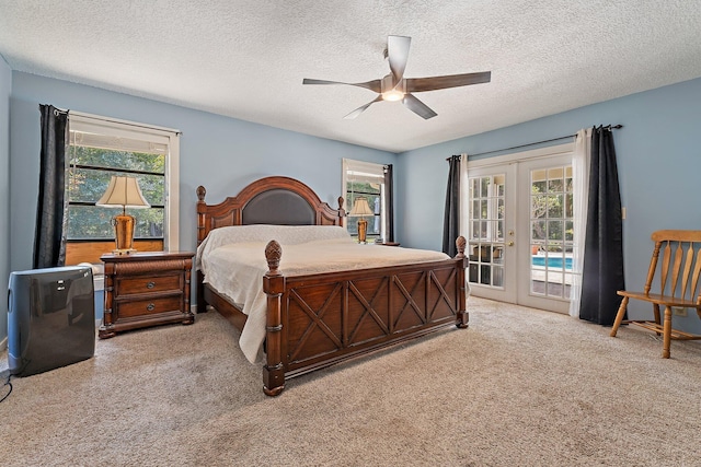 bedroom featuring french doors, a textured ceiling, carpet, and access to exterior