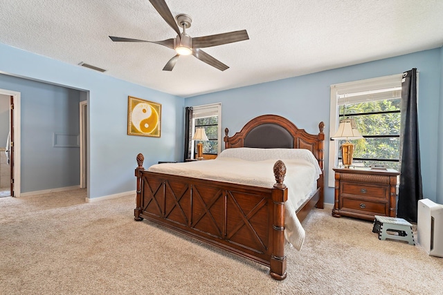 bedroom with carpet floors, a textured ceiling, visible vents, and multiple windows