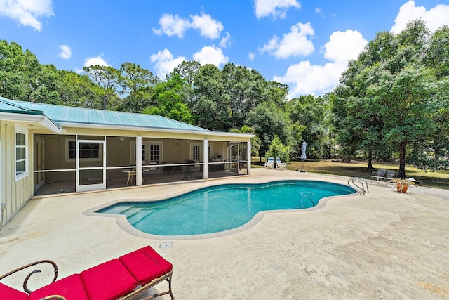 pool with a sunroom and a patio area