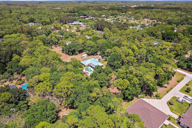birds eye view of property featuring a forest view