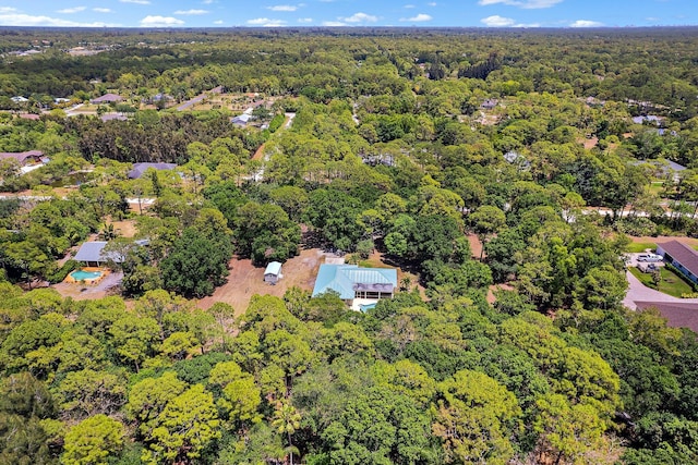 birds eye view of property featuring a wooded view