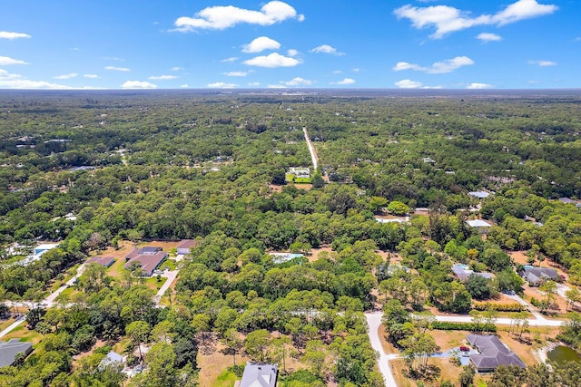 drone / aerial view with a wooded view