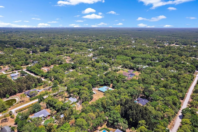 drone / aerial view featuring a forest view