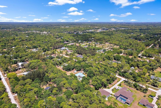 birds eye view of property with a wooded view