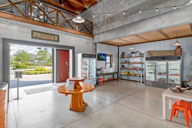 interior space with a towering ceiling and concrete flooring