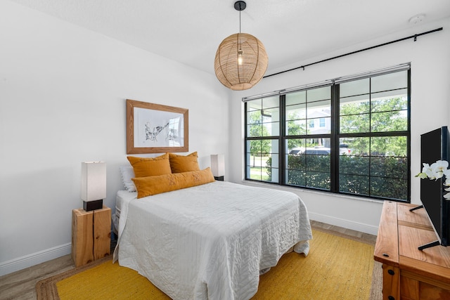 bedroom featuring baseboards and light wood-type flooring