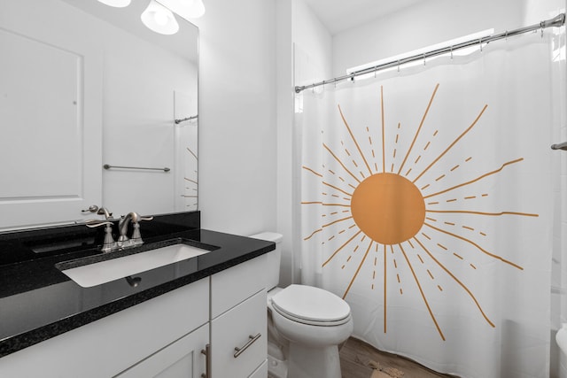 full bathroom featuring vanity, curtained shower, toilet, and wood finished floors